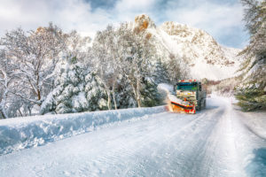 Winter scenery with snowplow truck clearing the road near Valberg . Location: Valberg, Vestvagoy, Lofotens, Norway