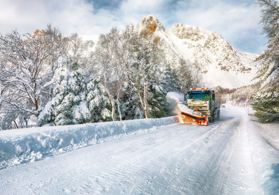 Winter scenery with snowplow truck clearing the road near Valberg . Location: Valberg, Vestvagoy, Lofotens, Norway